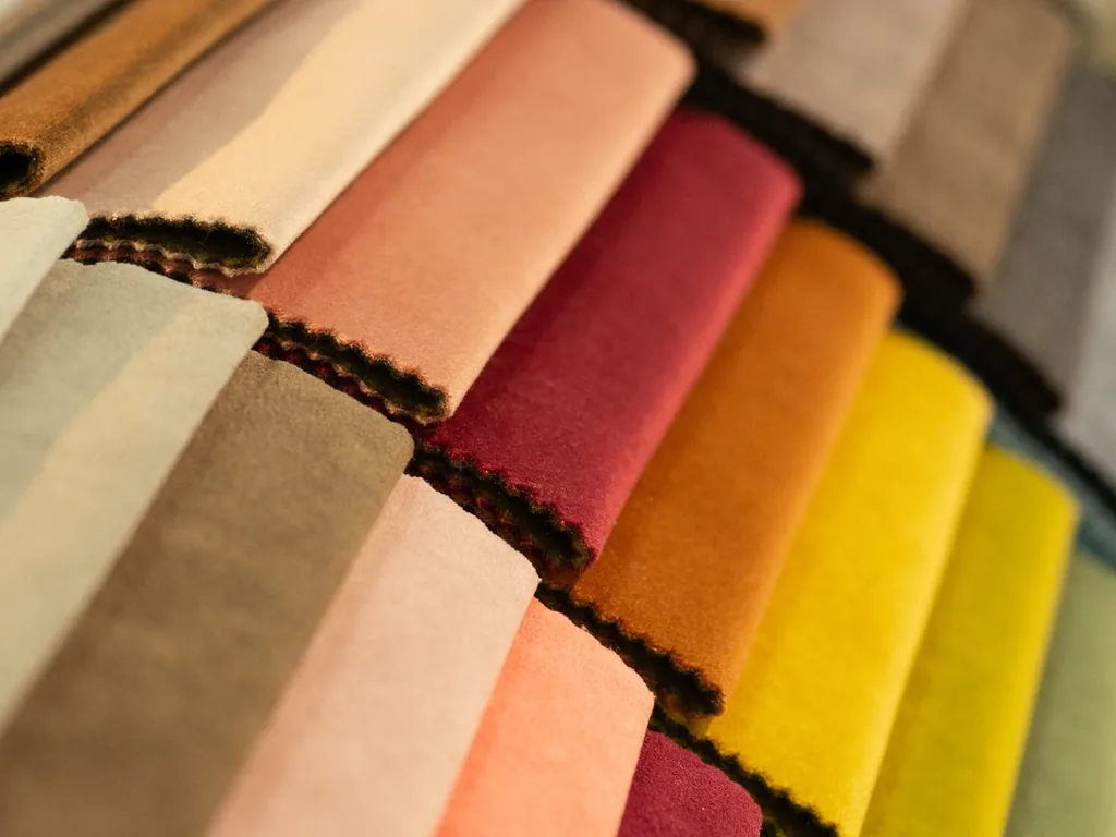 Folded fabric swatches stacked for a reseller to look through
